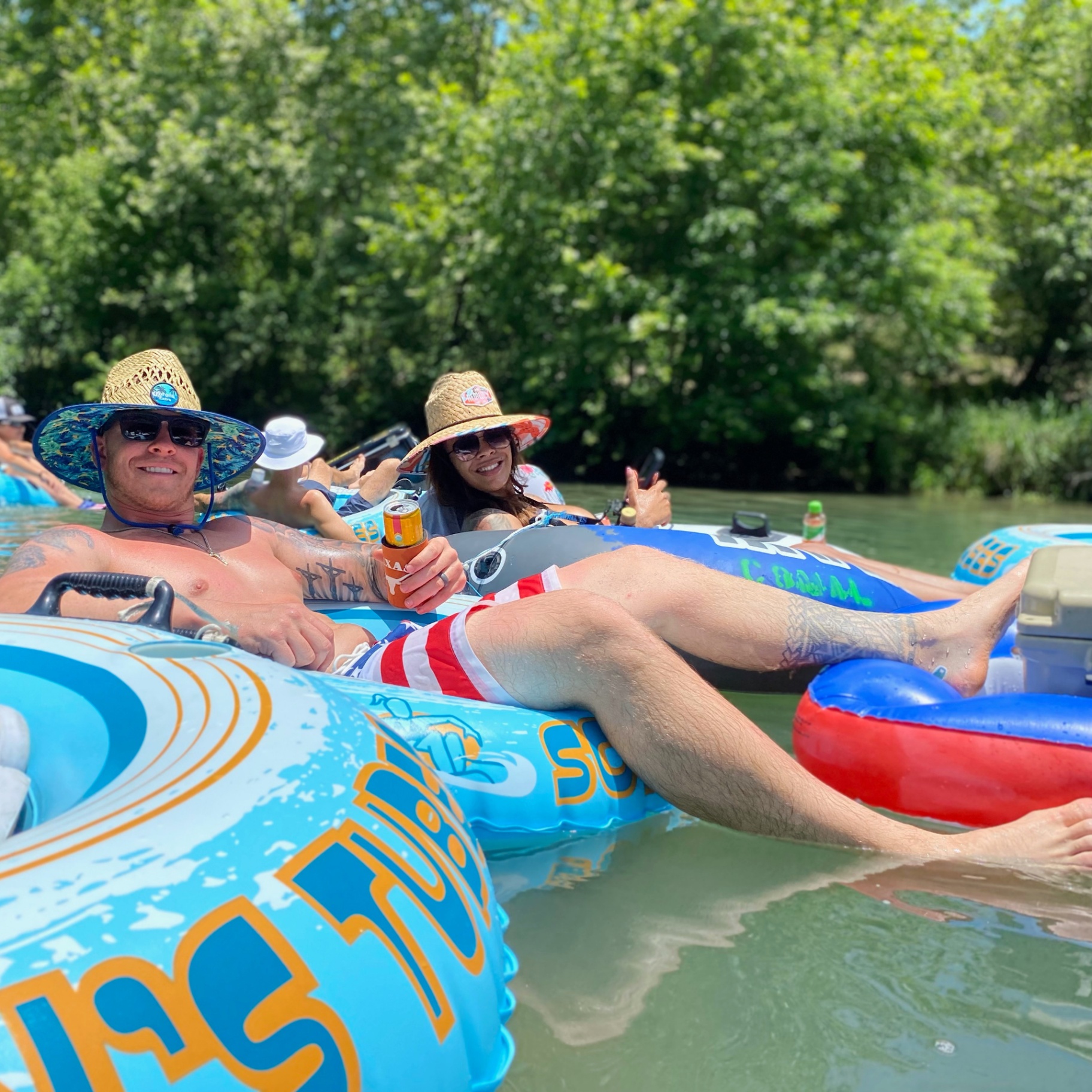 Couple relaxing on river tubes