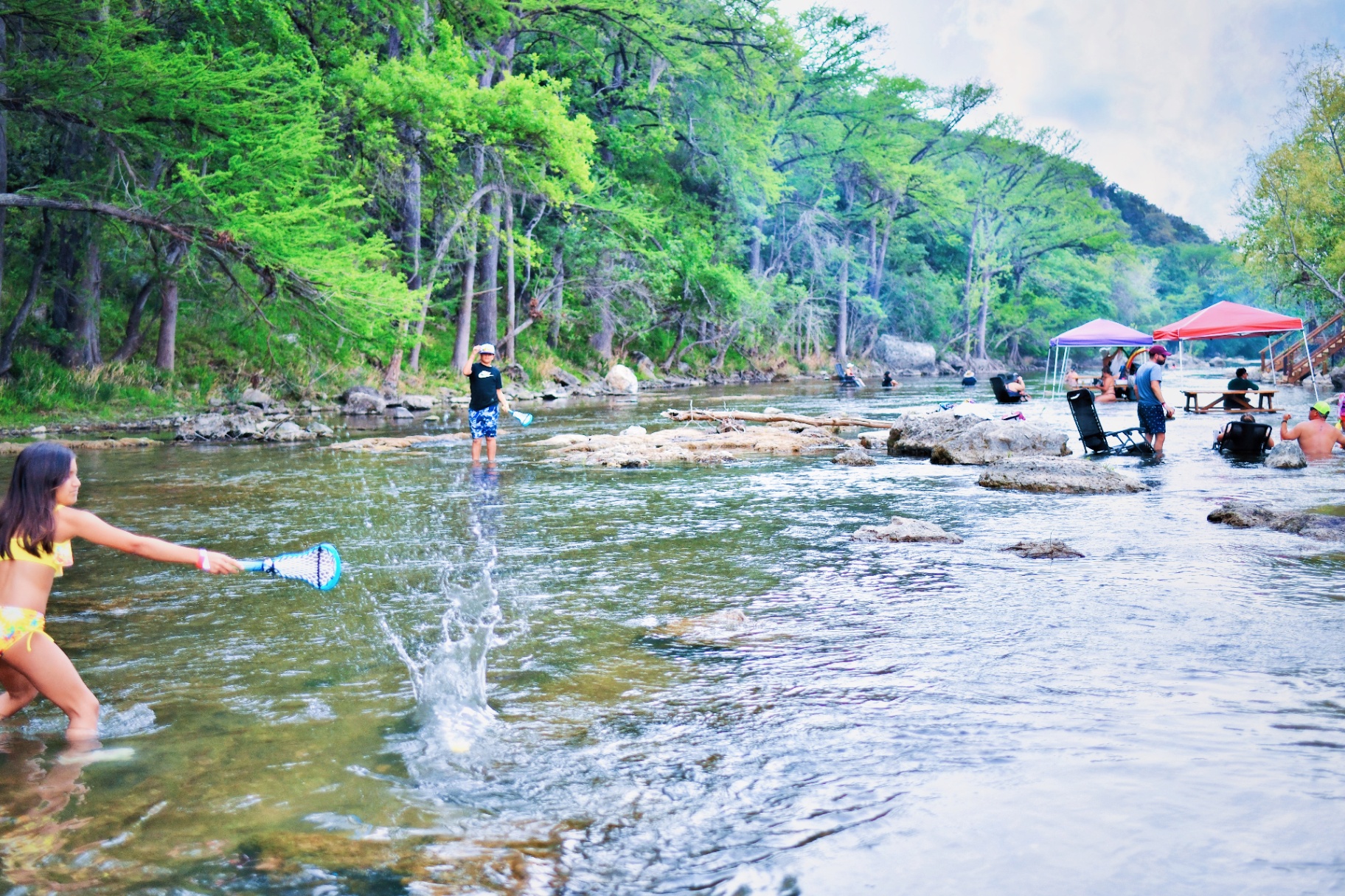 Kids playing in the shallow river