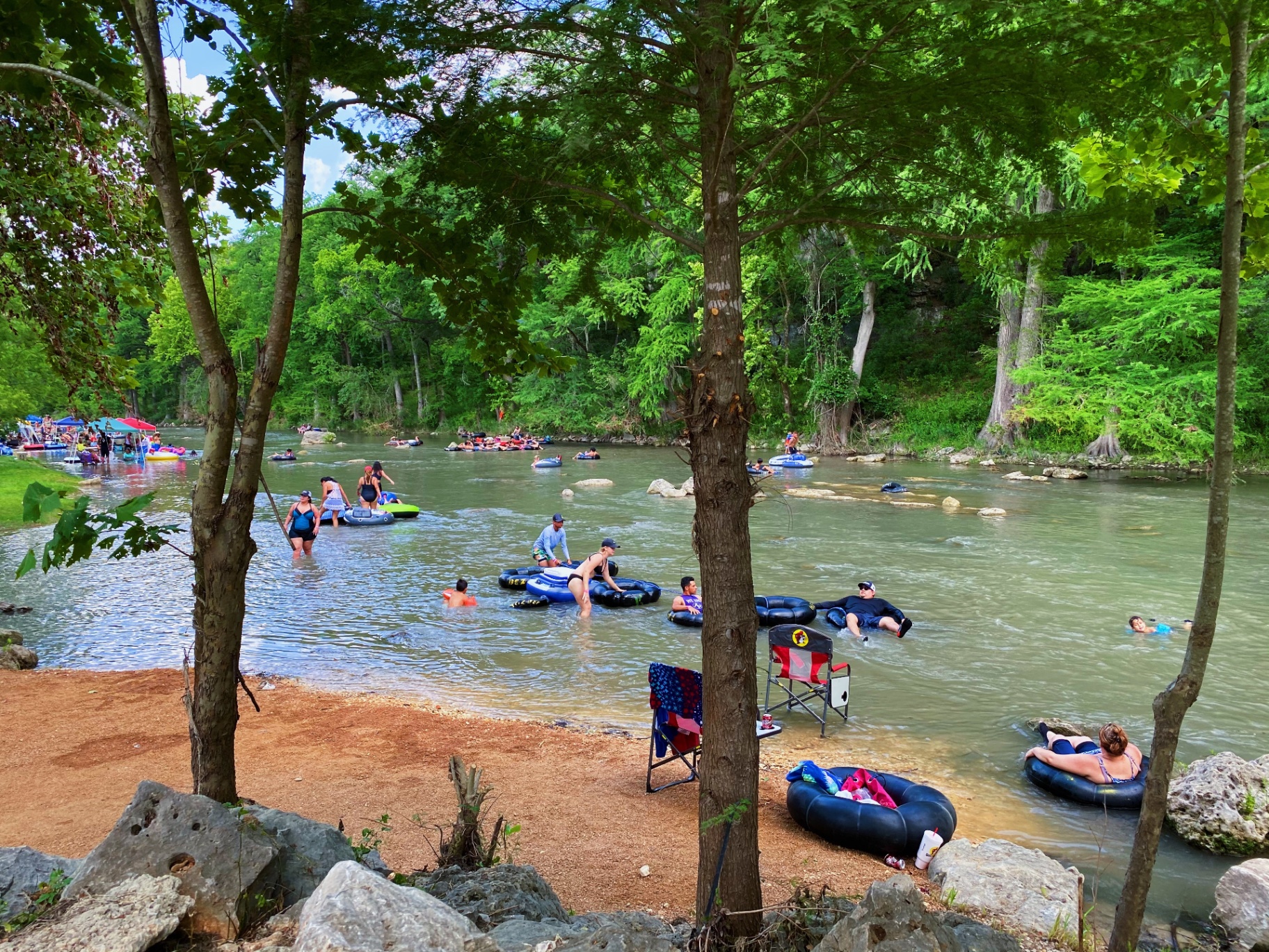 Guests tubing and swimming on the river