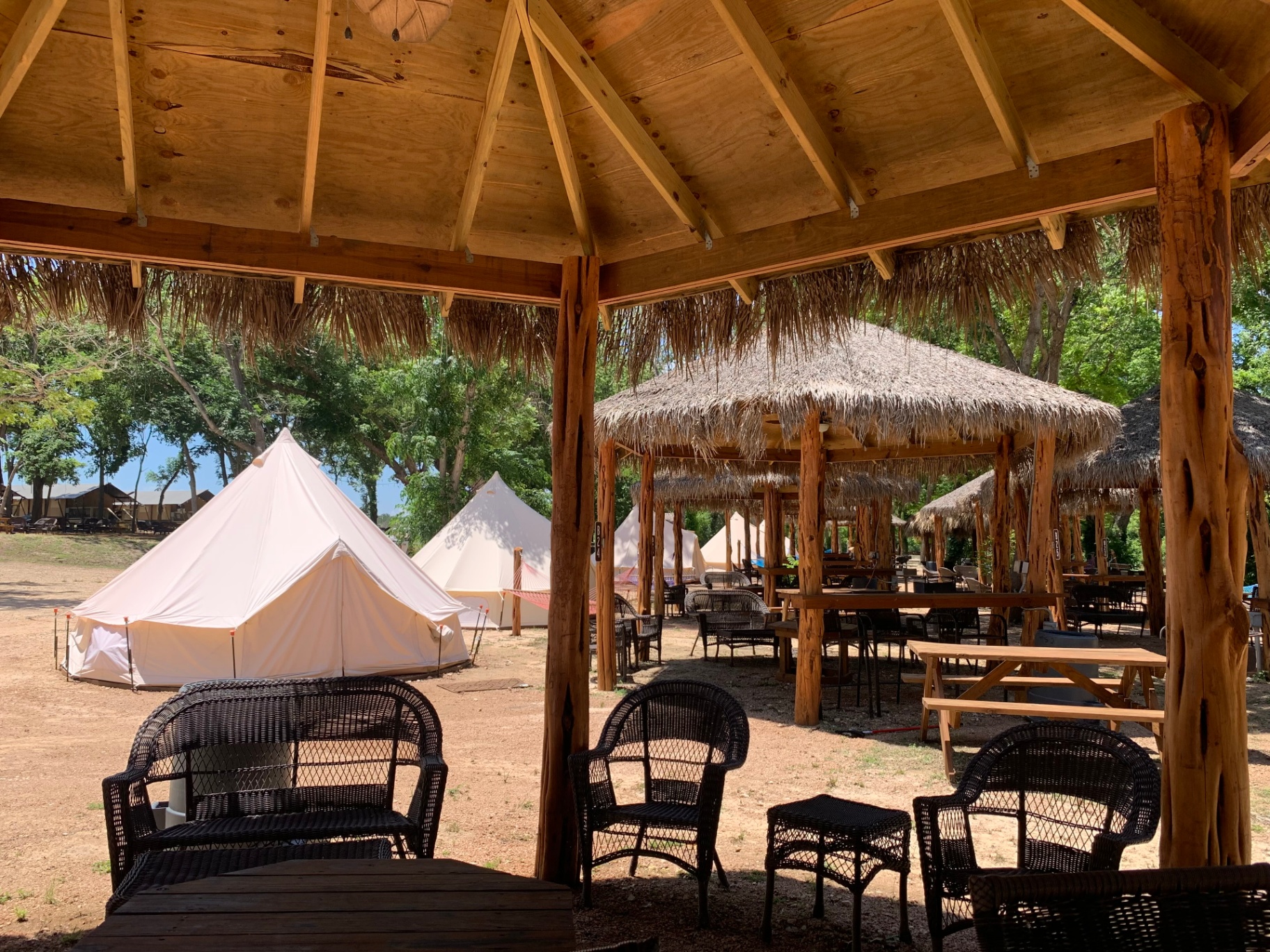 Glamping tents with tiki lounge seating area