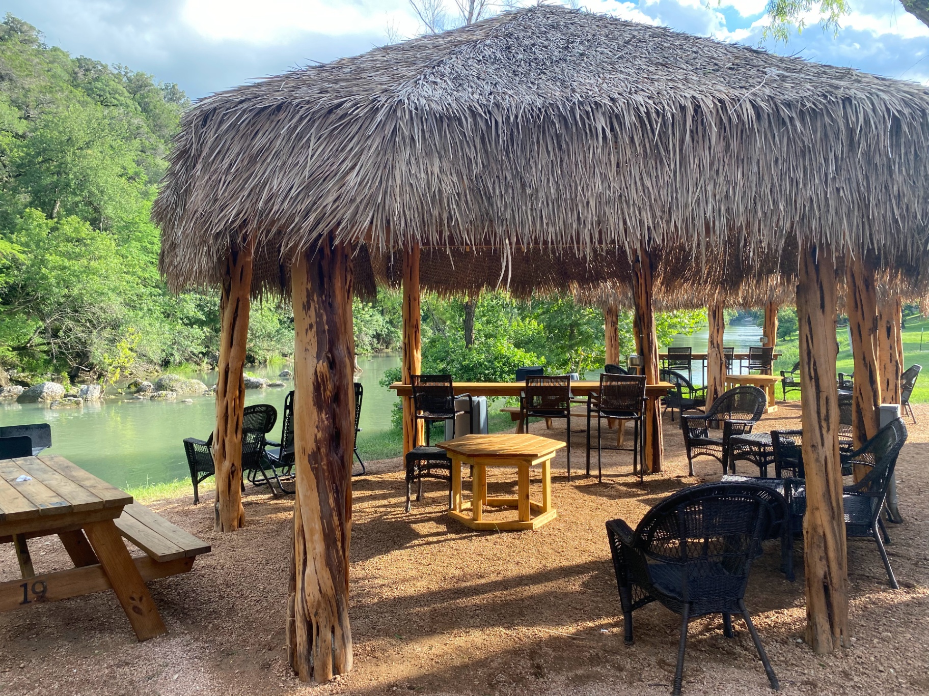 Riverside cabana with seating and tables